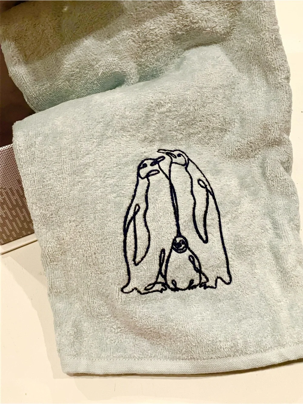 Light Blue Plush Throw with Embroidered Penguin Design